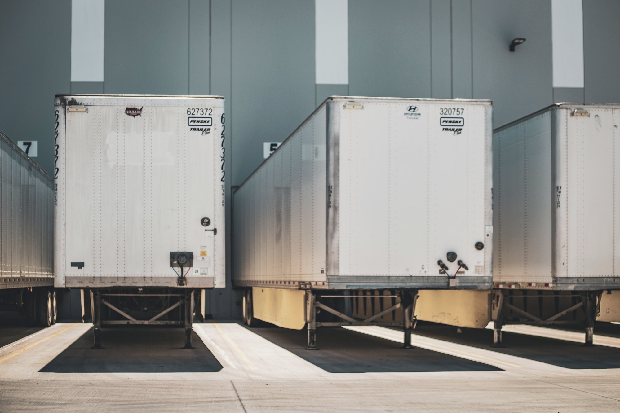 Freight trailers backed into a distribution center loading dock